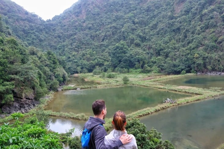 Devant des bassins d’élevages de poissons